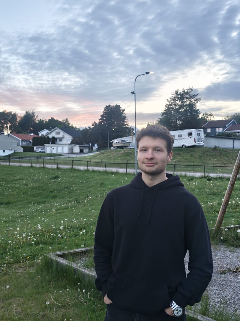 Dumitru Ciugunov, standing in a field at dusk.